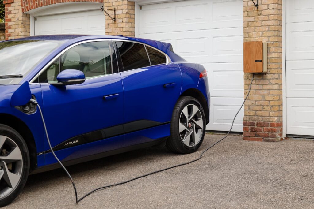 Electric car plugged into home charging station