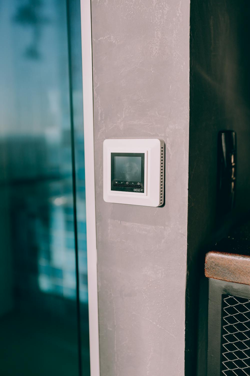 Digital thermostat display on a living room wall