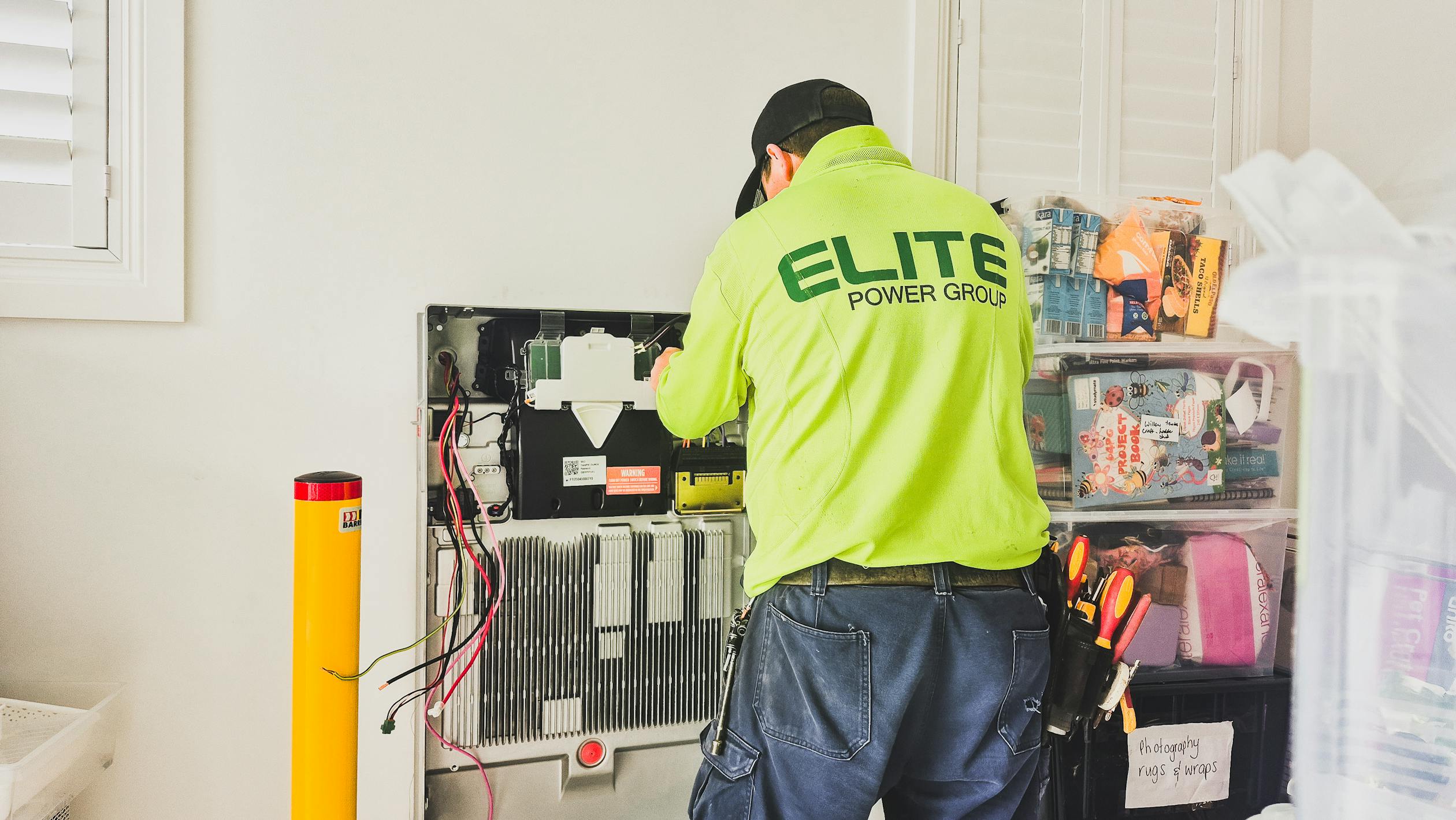 Technician installing a home battery storage system