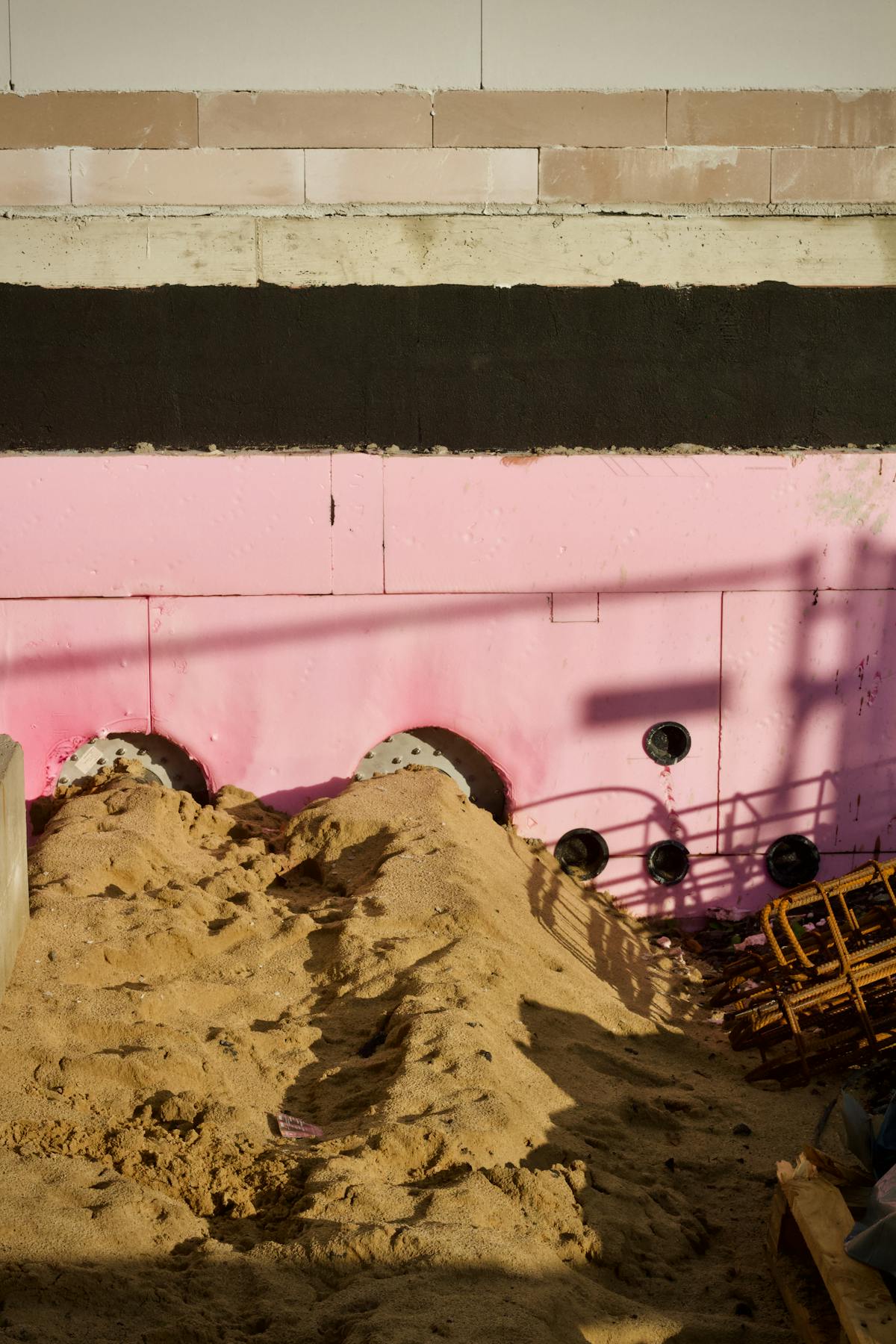 Pink insulation panels on a building site