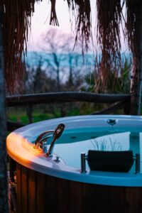 Outdoor hot tub in a garden at dusk