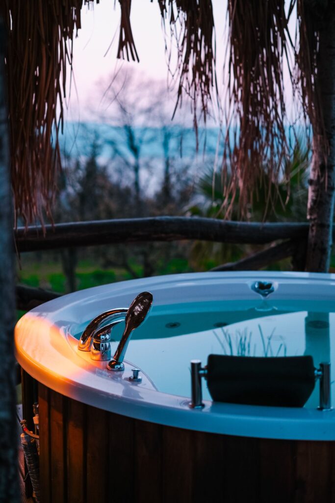 Outdoor hot tub in a garden at dusk
