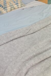 Cosy warm blanket on a made bed in a bedroom